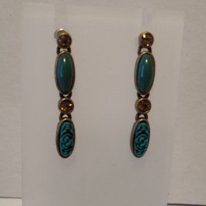 Gold tone dangle earrings with green stones